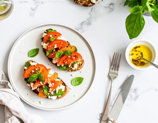 Open-faced tomato basil sandwiches on feta, yellow dip, marble table, greenery, inviting lunch.
