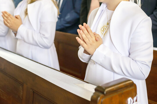 Young child receiving the Eucharist for the first time during a Catholic Mass. First Holy Communion marks a key moment of faith, purity, and tradition in Polish religious life.