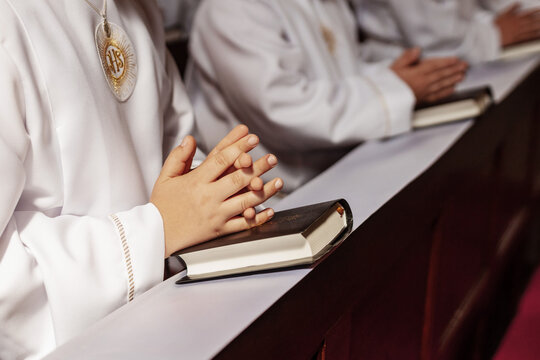 Young child receiving the Eucharist for the first time during a Catholic Mass. First Holy Communion marks a key moment of faith, purity, and tradition in Polish religious life.