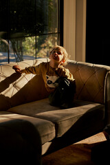 Little caucasian boy is playing in the hotel lobby by himself.
