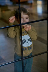 Little caucasian boy is playing in the hotel lobby by himself.