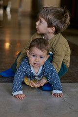 Brother and sister playing indoors.