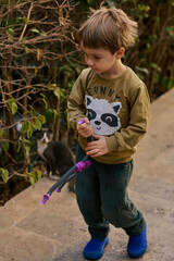 Little boy playing with his toy outdoors.