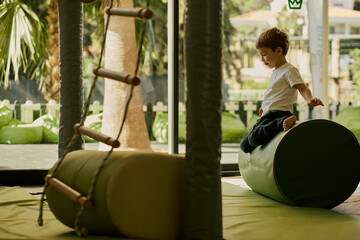 Little boy plating in the indoor kids club.