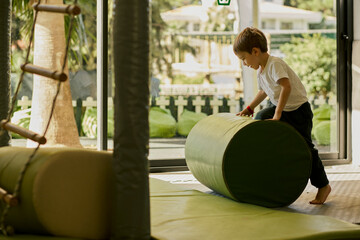 Little boy plating in the indoor kids club.