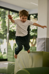 Little boy plating in the indoor kids club.