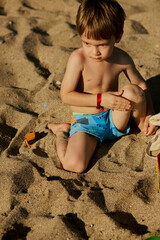 little boy playing on the beach
