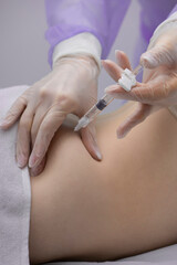 Physiotherapist doing an injection to the back of a patient