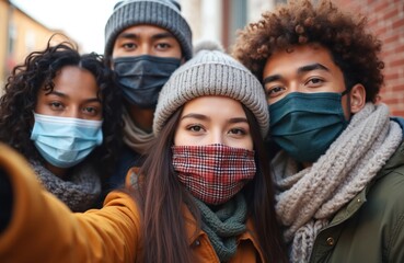 Group multiracial friends take selfie wearing face masks winter clothes. Young people enjoy time together. New normal friendship concept. People wearing face masks smiling, happy in city.