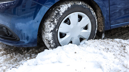 Car Wheel Stuck in Deep Snow Capturing Struggles Winter Driving Conditions.