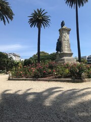 statue in park with roses