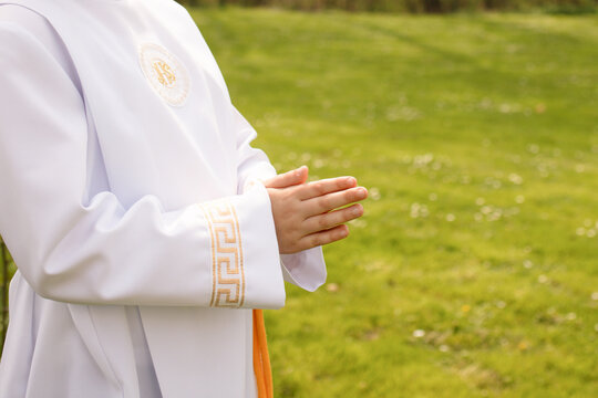Close-up view of a child’s hands joined in prayer during First Holy Communion. A symbolic moment of faith, innocence, and religious devotion. Gifts and spiritual meaning combined.