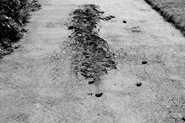 Road damage in Sofia, Bulgaria. Black and white retro style photo.