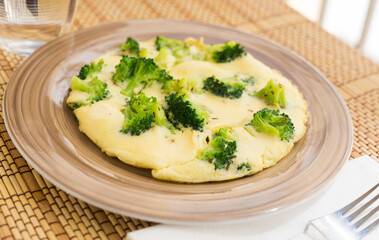 Wholesome breakfast. omelet with broccoli on brown plate