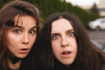 Close-up of two surprised female faces