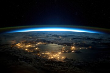 Fototapeta premium A breathtaking view of Earth from space, showcasing city lights gleaming through clouds and a bright atmospheric glow against the starry expanse.