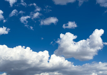 Beautiful white clouds in a blue sky background. Cotton clouds in blue sky. Natural view of clouds. Meteorology and environment concept background. Cumulus clouds background. Cotton cloud in summer. 
