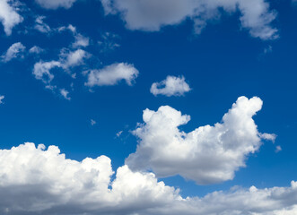 Beautiful white clouds in a blue sky background. Cotton clouds in blue sky. Natural view of clouds. Meteorology and environment concept background. Cumulus clouds background. Cotton cloud in summer. 