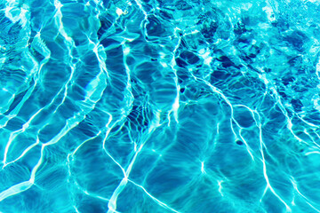 Ripples on the surface of the water in a blue swimming pool