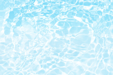 Blue water with ripples on the surface. Defocus blurred transparent blue colored clear calm water surface texture with splashes and bubbles. Water waves with shining pattern texture background.