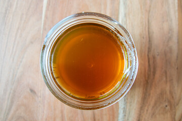 Glass bowl of natural honey on the wood table.