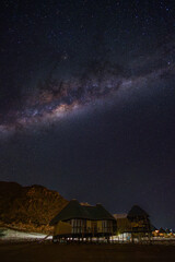 Milky Way over straw-thatched huts in the Namibia desert in Sousvlei.