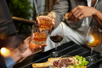 Businessman with friends and whiskey for a party in a bar or restaurant.