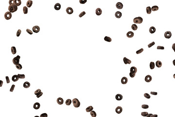 Chocolate rings cereal spill out into a bowl. Breakfast.