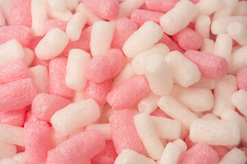 Pink and white box filler as a background. Top view.