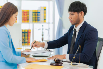 Lawyer providing legal advice and guidance and client support concept. Asian lawyer or judge providing advice by meeting with Asian female client.