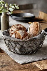 Freshly baked bread displayed in wire basket on rustic table
