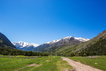 Road in caucasus Mountains spring landscape. Karachay-Cherkessia, Russia