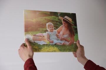 Canvas print. Woman with photo on light background, closeup