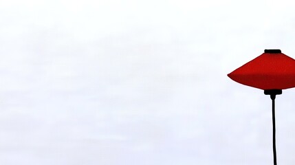 Red lamp with minimalist design, and white background.