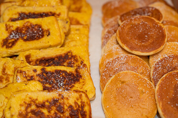 Assortment of freshly baked breads, beautifully arranged and ready to enjoy.