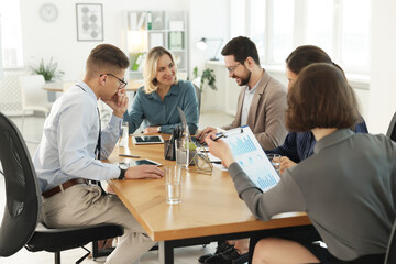 Obraz premium Coworkers working together at wooden table in office