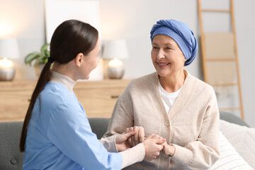 Fototapeta premium Nurse supporting woman with cancer at home