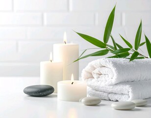 Zen Spa Still Life with White Candles, Black Stones, Rolled Towels and Green Leaves on White Background
