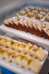Close-up of rich and moist marble cakes arranged at a dessert buffet counter, showcasing their signature swirl pattern in a luxury hotel or restaurant dining setup.