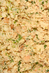 A thoroughly mixed preparation for bread dumplings, featuring moist bread, chopped herbs, and other...