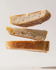Three slices of bread levitating against a plain background