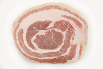 a single roll of rolled pancetta with a prominent spiral pattern of meat and fat on a white background