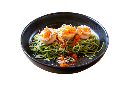 Spaghetti with shrimp and orange crab roe with seafood salad served on black plate. Green tea spaghetti noodles beautiful and delicious Italian food. Isolated on cutout PNG or transparent background.