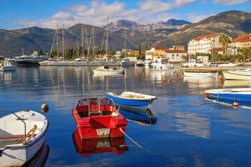 Beautiful winter Mediterranean landscape. Montenegro, Adriatic Sea. View of Bay of Kotor near Tivat city, Seljanovo village. Fishing boats and sailboats on water