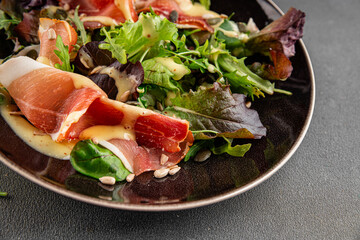 Salad meat jamon green lettuce leaf appetizer food fresh gourmet food background on the table rustic food top view copy space