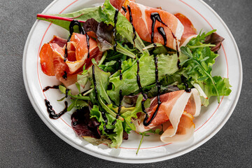 Salad meat jamon green lettuce leaf appetizer food fresh gourmet food background on the table rustic food top view copy space