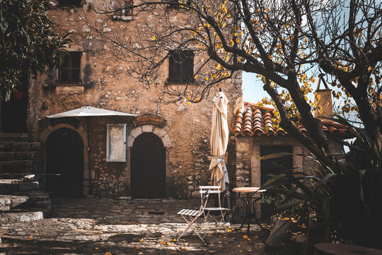 street view in the old town of eza village in cote d'azul, france, on a quiet sunny day. detail of a closed bar