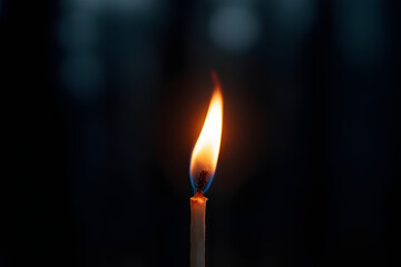 burning candle in the dark