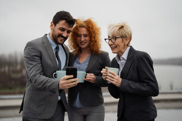Group of business people have fun on roof at coffee break