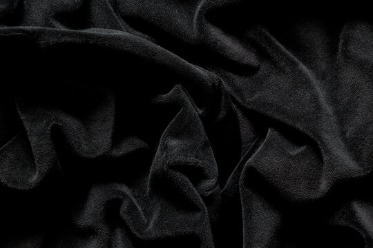 Black velour fabric wavy as background, women's velour tracksuit